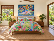Load image into Gallery viewer, A tropical floral bedding set with matching pillowcases on a wooden bed frame, styled in a bright bedroom with a large colorful painting above the bed and plants around it.