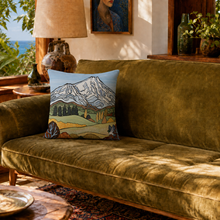Load image into Gallery viewer, A cushion cover designed by Miranda J Caird  derived from her painting of a Taranaki Landscape sitting on a velvet green sofa