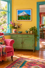 Load image into Gallery viewer, A colorful interior room scene with a framed mountain landscape painting on a yellow wall above a distressed green cabinet. A pink armchair with a patterned throw and blanket sits by a turquoise window, flowers decorate the cabinet, and a rug is visible in the foreground.